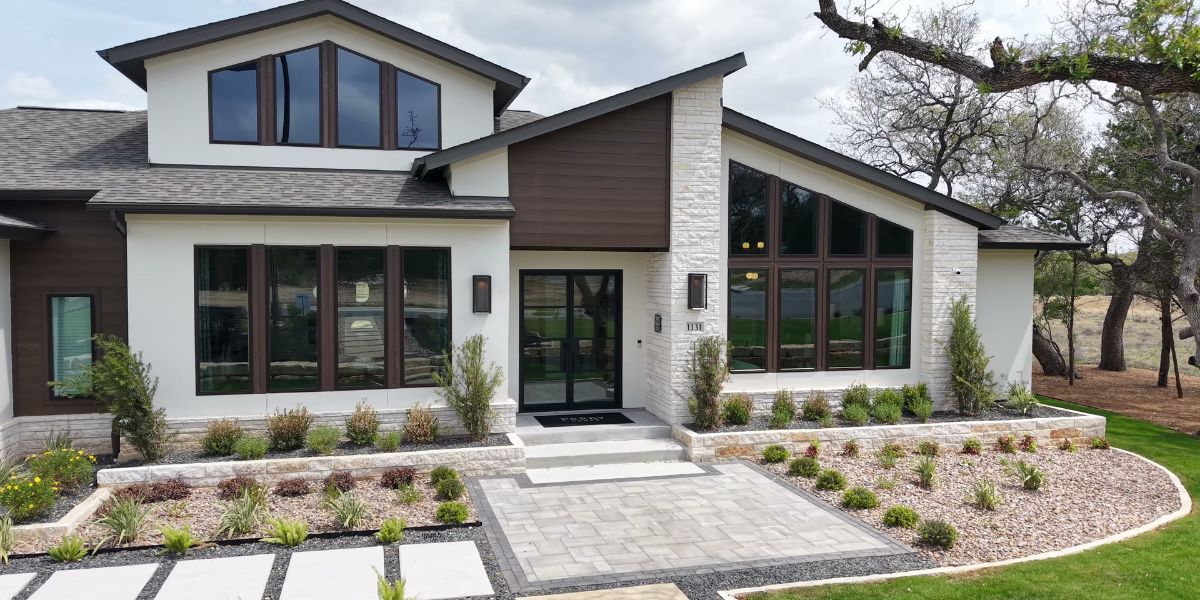 Modern home with a clear front walkway, defined rock beds, and neatly arranged landscaping.